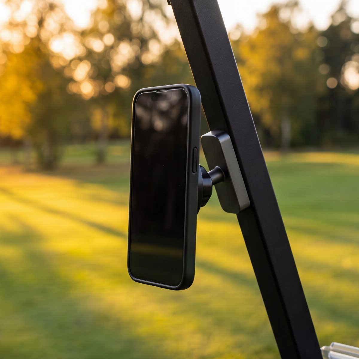 Smartphone held by a magnetic mount on a black golf cart frame.