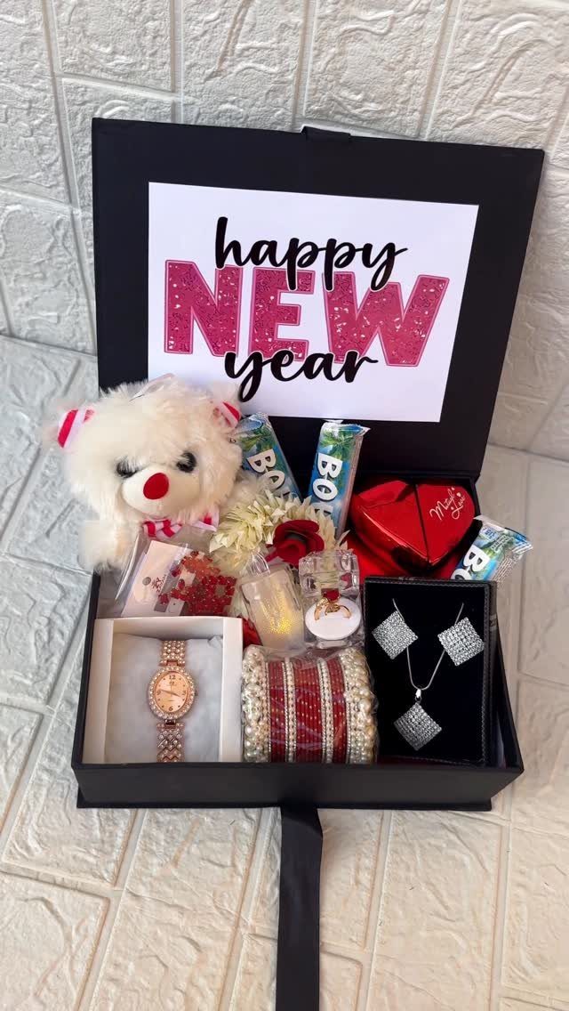 New Year gift box with teddy bear, jewelry, watch, and festive greeting card
