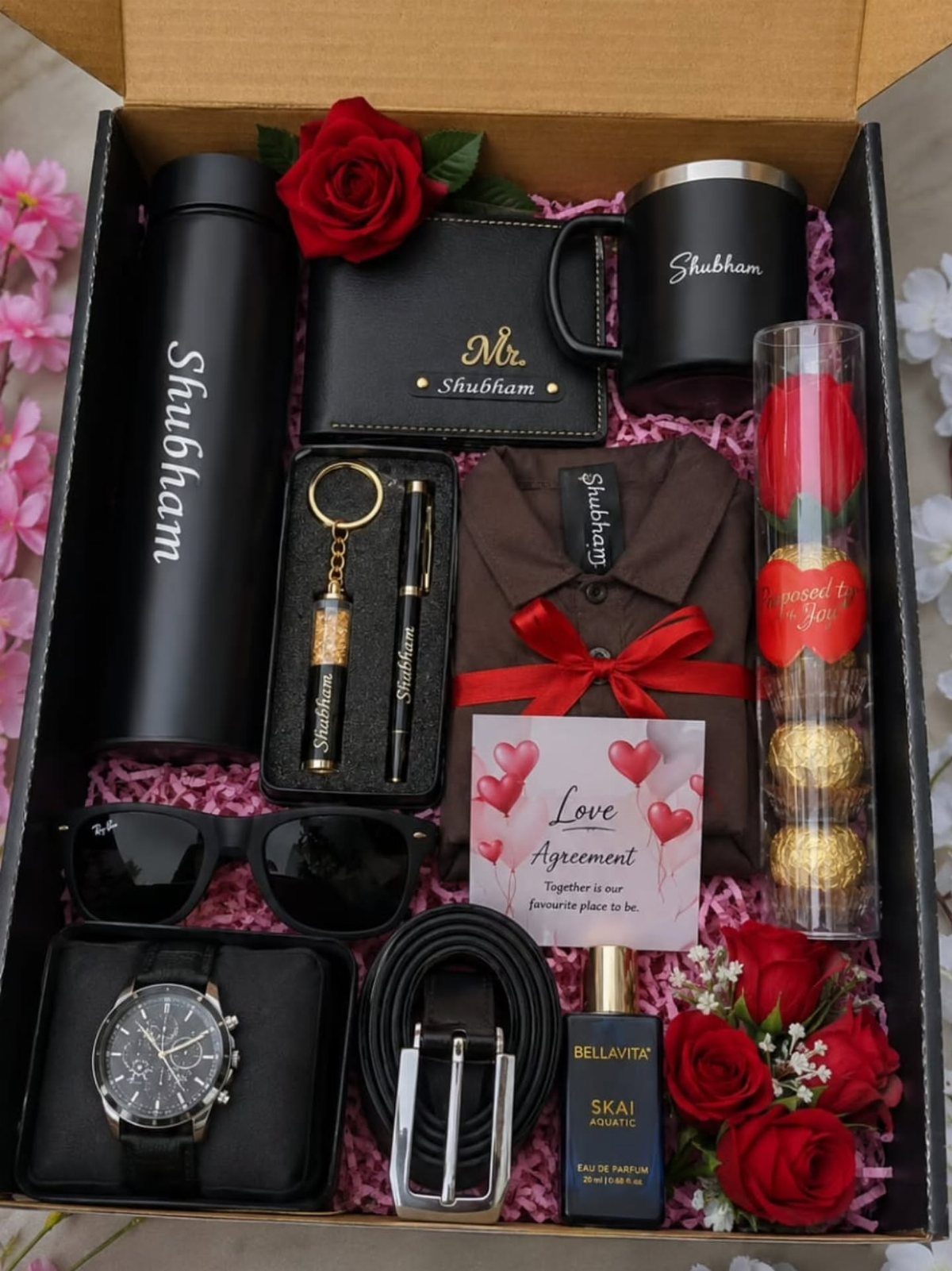 Personalized gift hamper for men with black accessories and red roses in a box