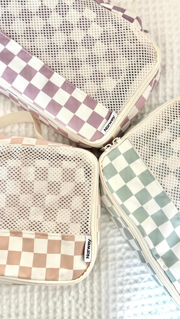 Three checkered mesh storage pouches in pastel colors on a white textured background.