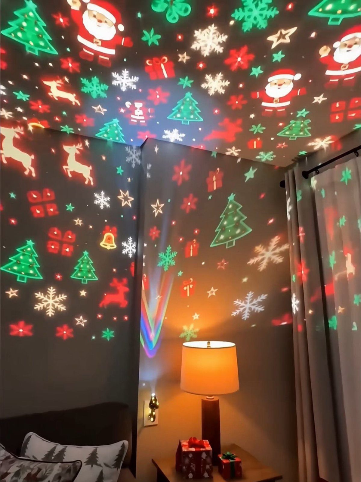 Christmas themed light projections of Santa and trees on a room's walls