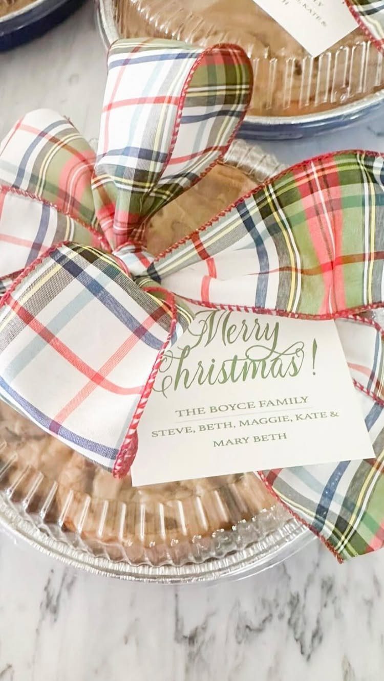 A holiday pie gift with a plaid bow and personalized family name tag.