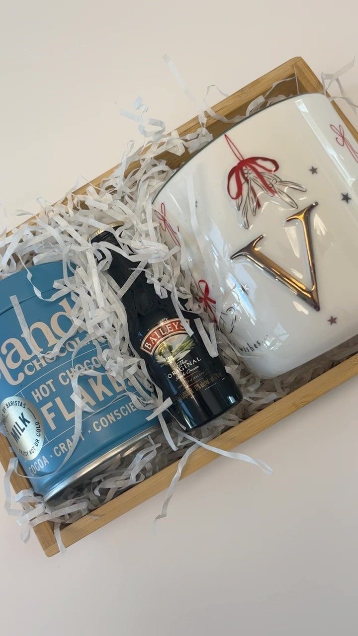 Hot chocolate gift set in a wooden box with a mug and liqueur bottle.