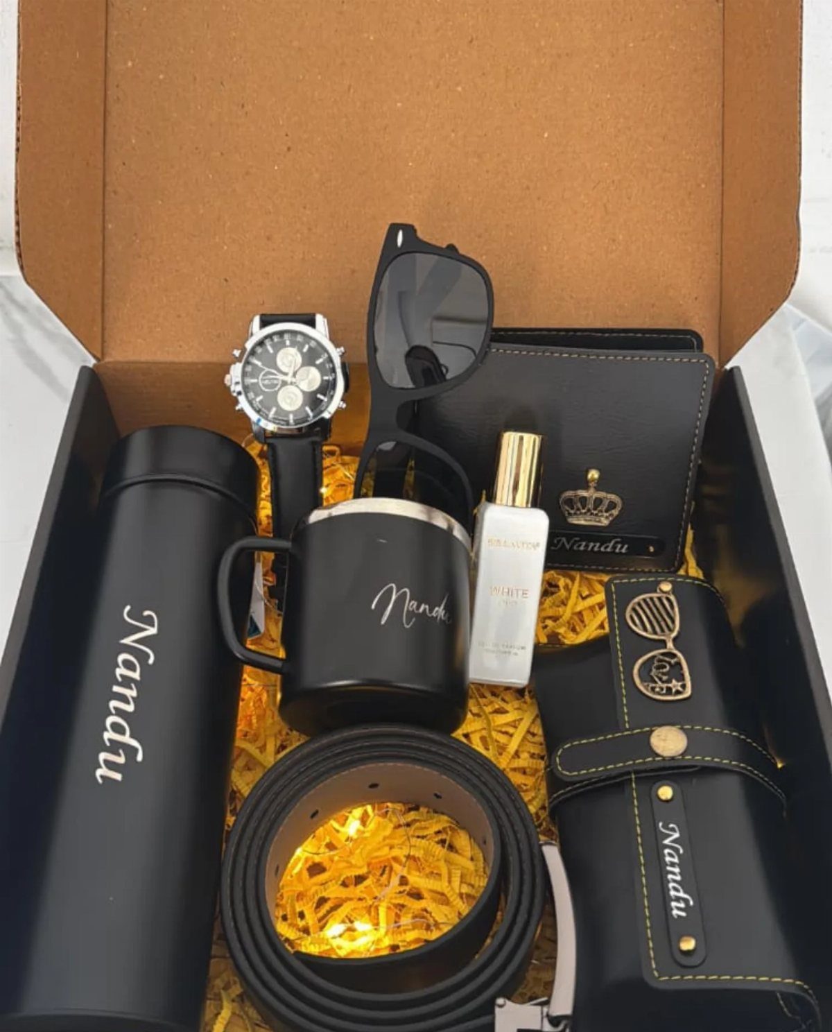 Personalized black gift set with wallet, watch, and thermos in a cardboard box.