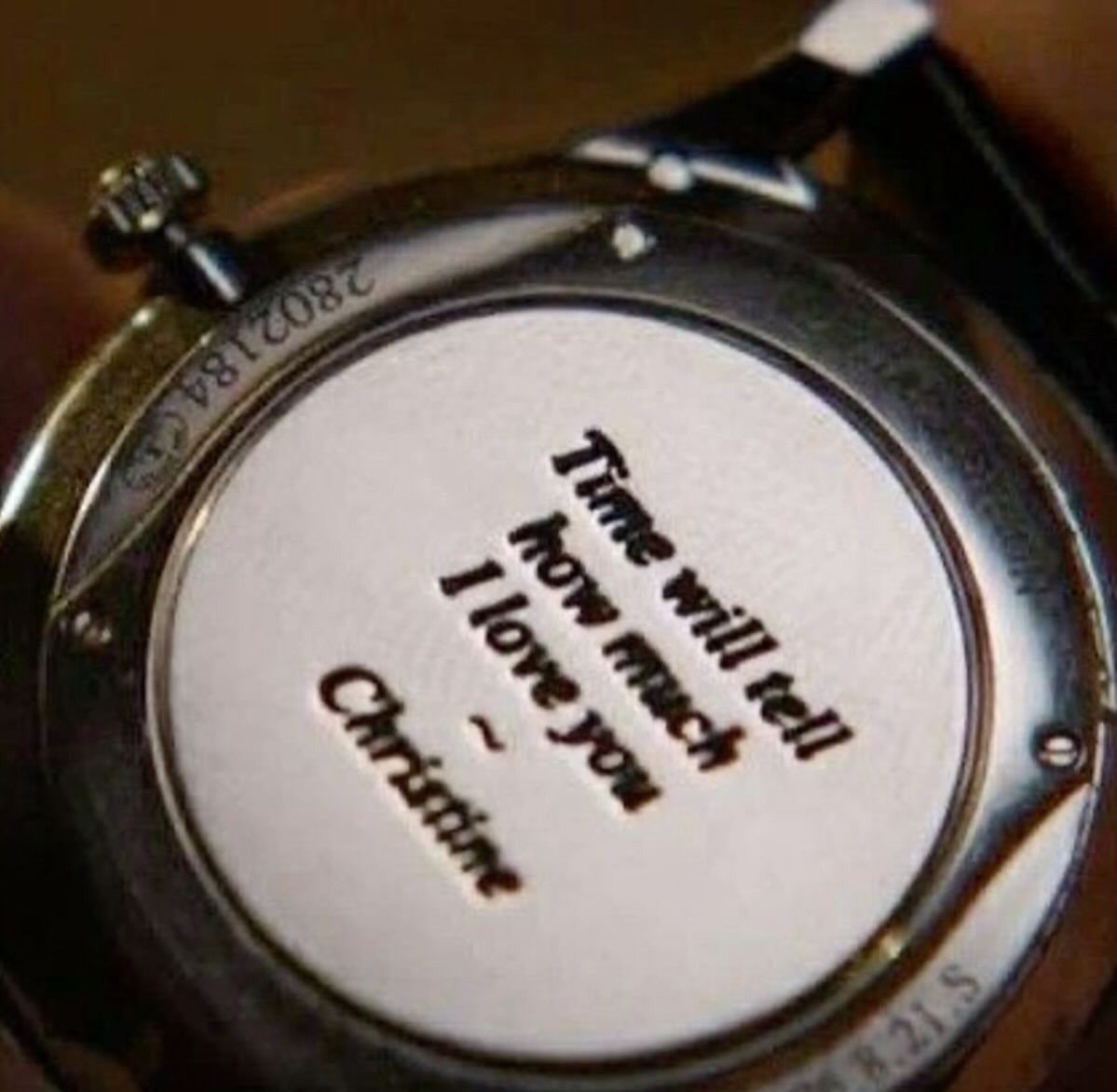 Engraved silver watch back with a romantic message and the name Christine.