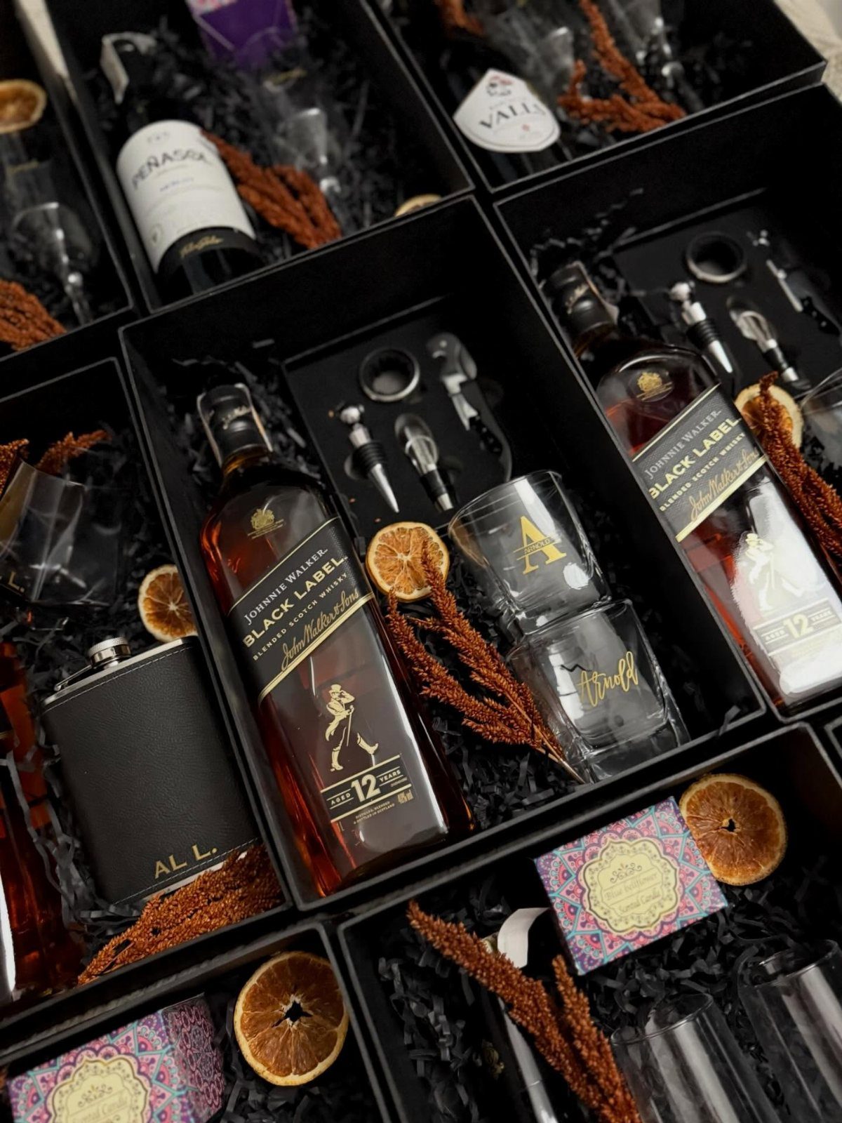 Whiskey gift set in a black box with a flask and glasses.