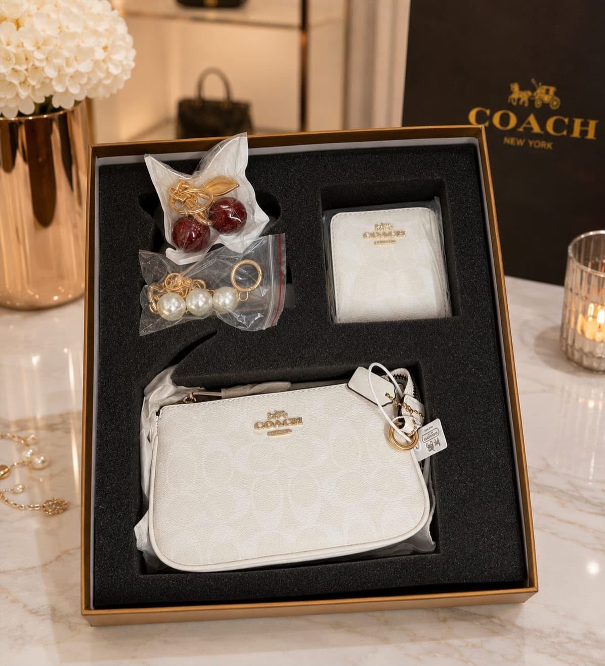 Coach luxury gift set with white bag, wallet, and jewelry in a box