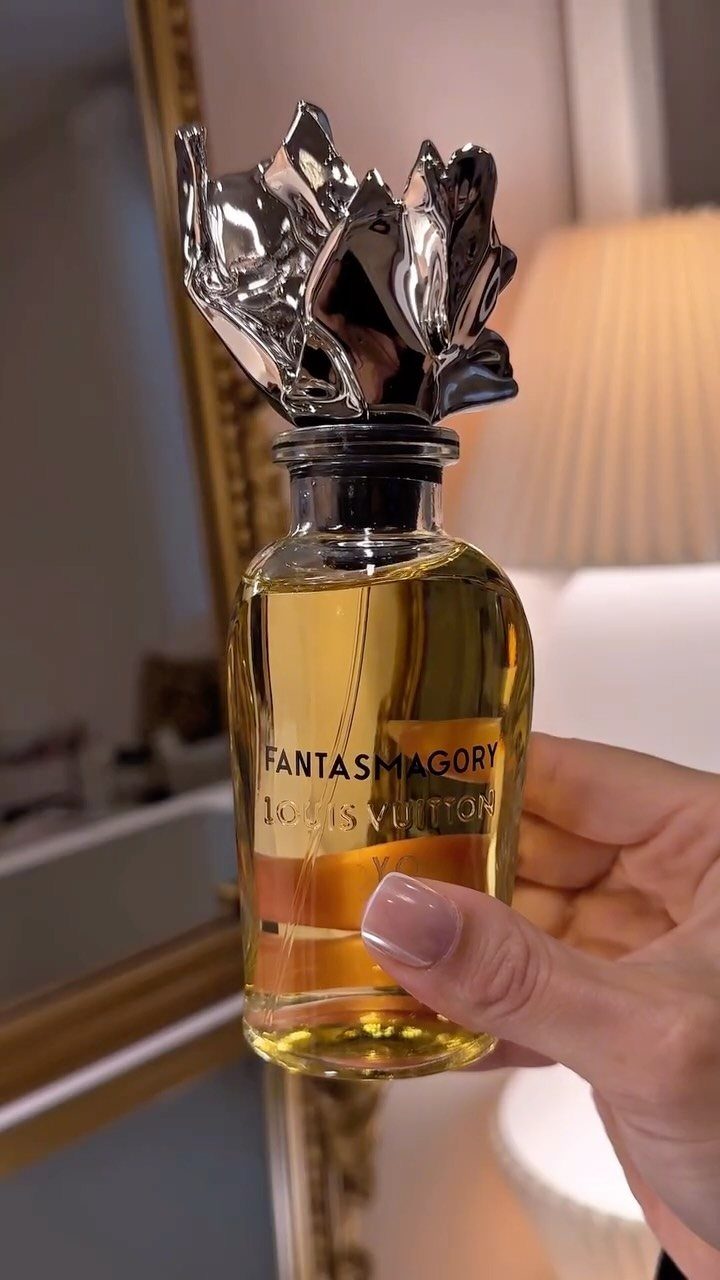 Louis Vuitton Fantasmagorie perfume bottle with a silver sculptural cap held by a hand