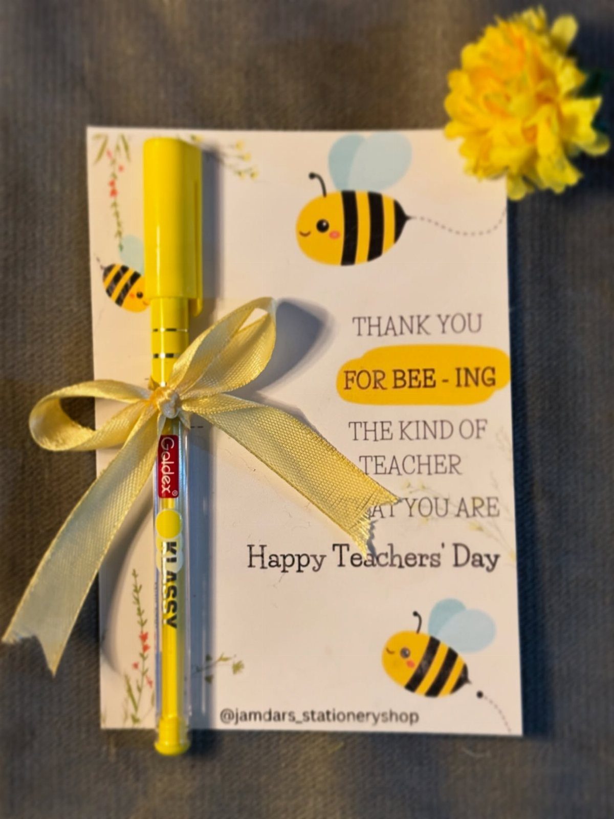 Yellow highlighter pen with gold ribbon on a bee-themed teacher appreciation card.