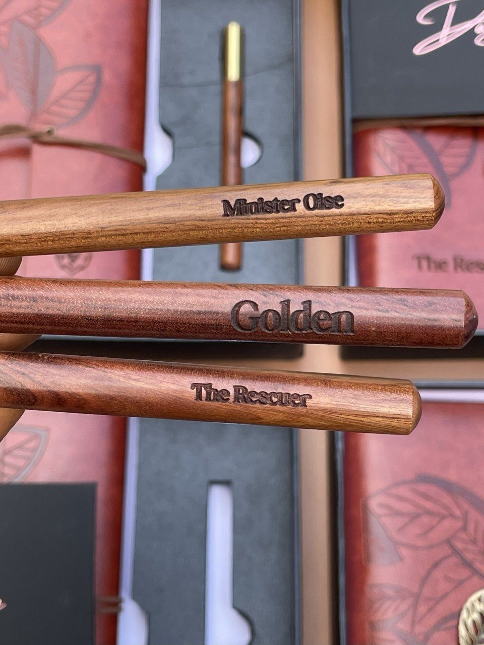 Engraved wooden pens resting on gift boxes as personalized meaningful gifts for husband