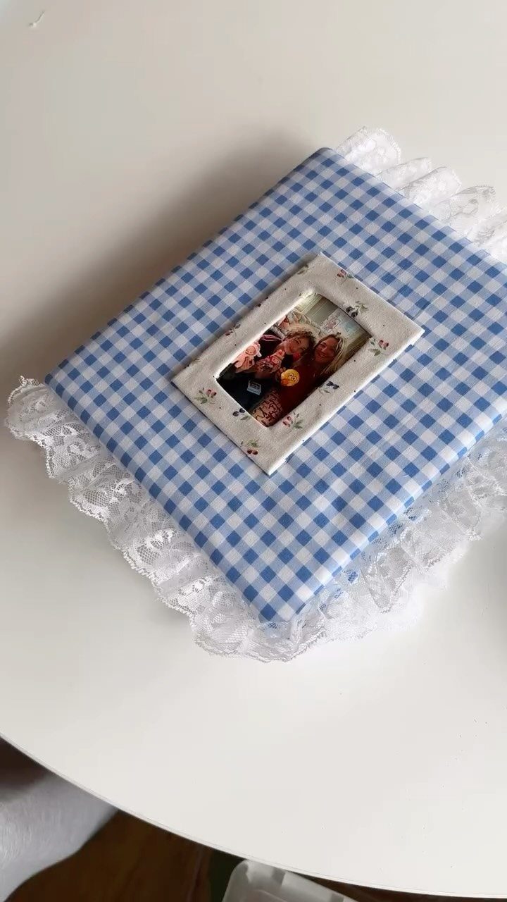 Gingham fabric covered photo album with lace trim and a small framed couple photo