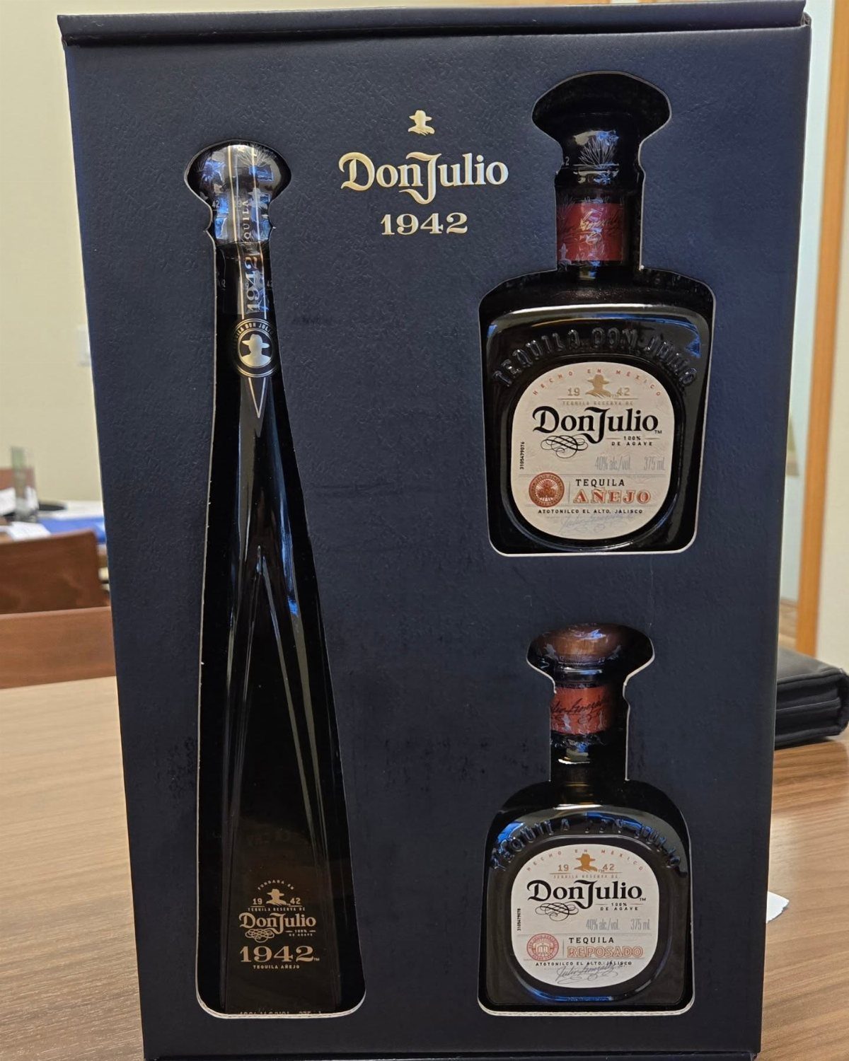 Don Julio tequila bottles arranged in a dark blue branded gift box.