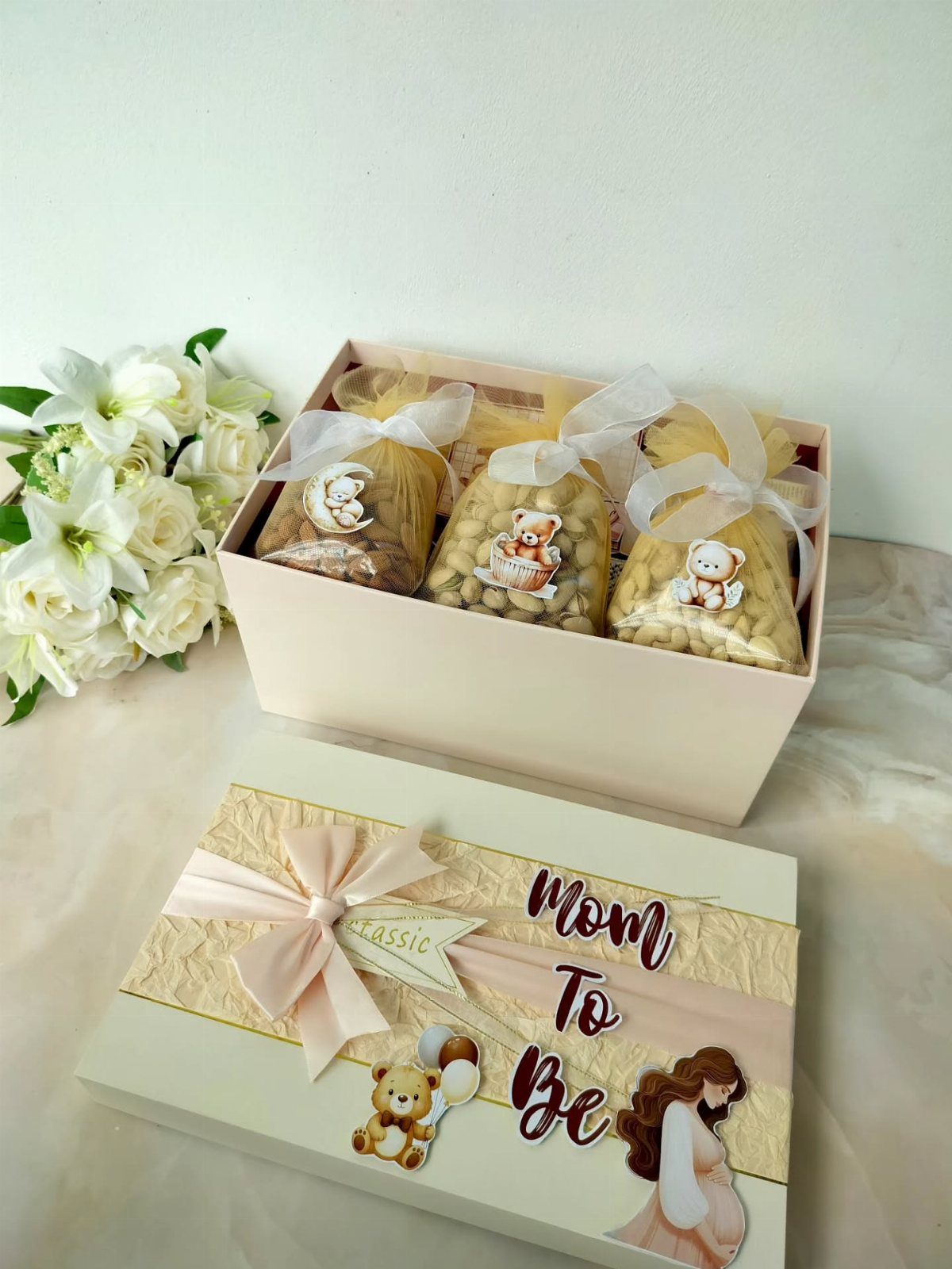 Pink gift box for a mom to be with treats and floral accents