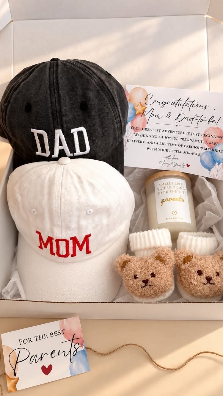 Gift box with Mom and Dad baseball caps, bear slippers, and a candle.