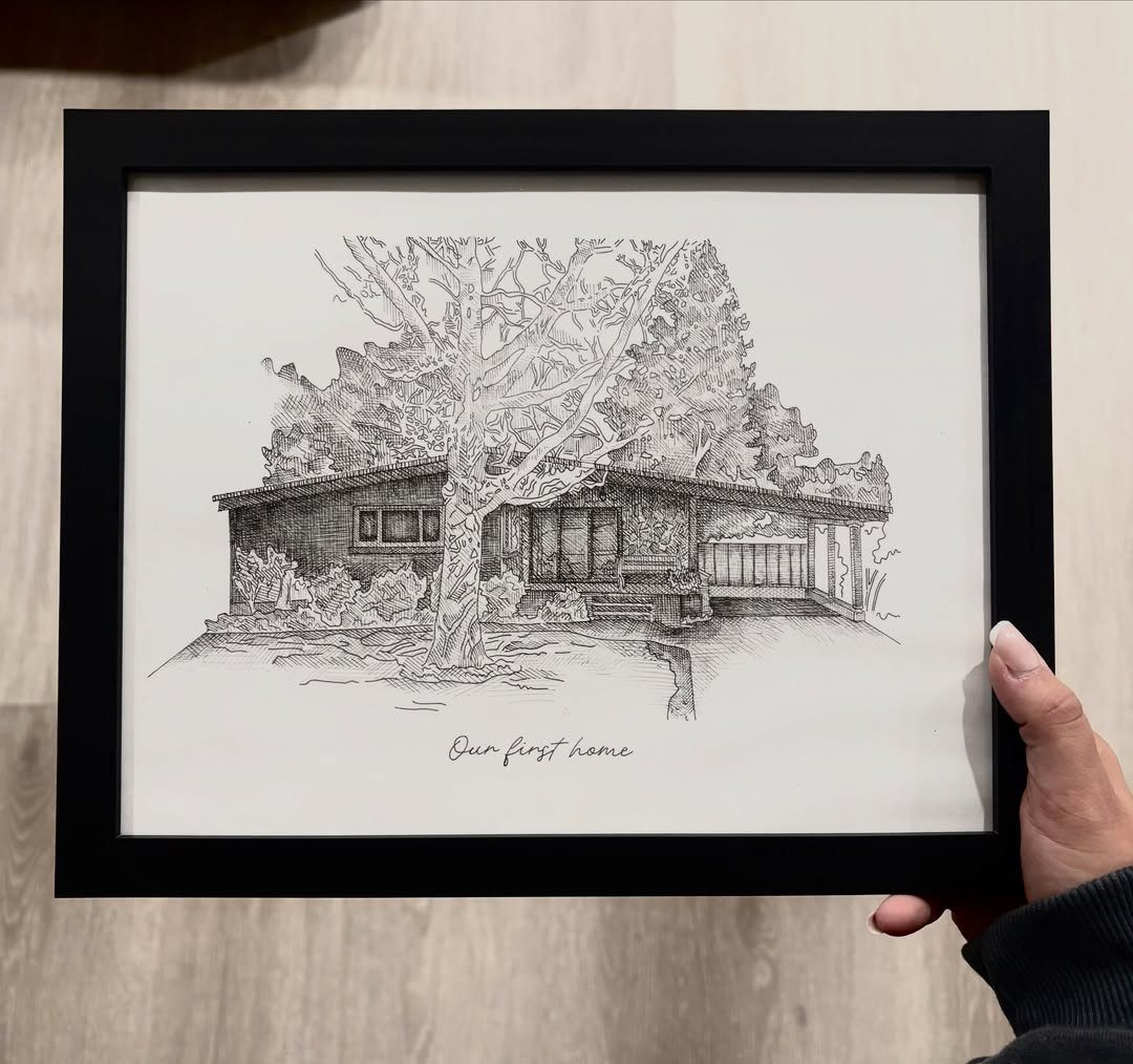 Black framed ink drawing of a house and tree titled Our first home