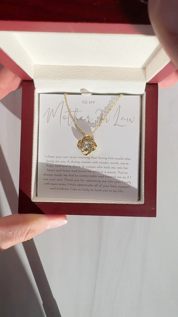 Gold flower pendant necklace in a red box with a heartfelt message card.