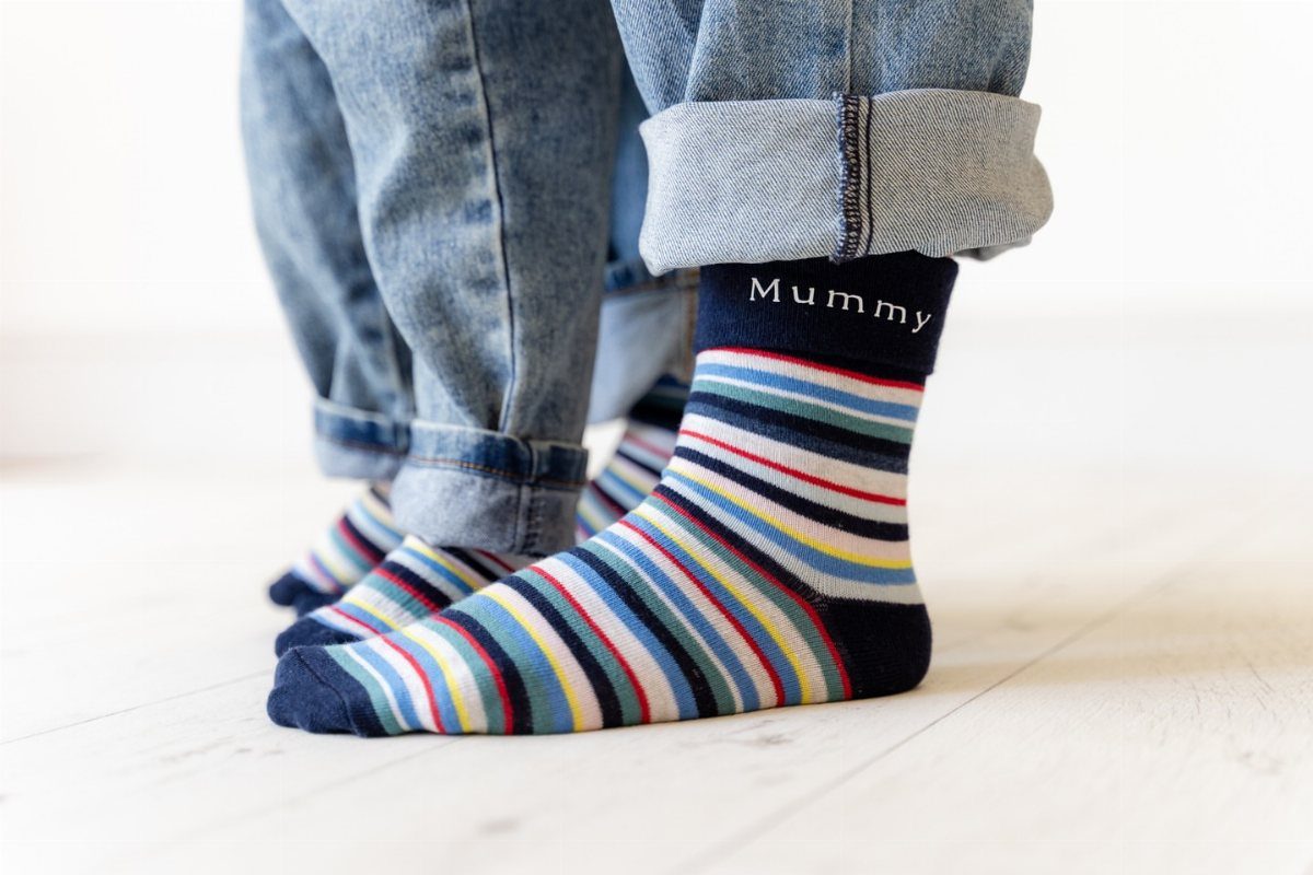 Striped socks with Mummy written on the cuff worn with blue jeans.