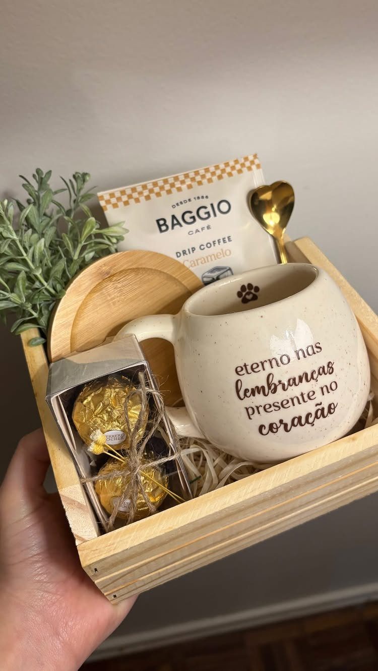 Wooden gift crate with a white mug, drip coffee, and gold chocolates.