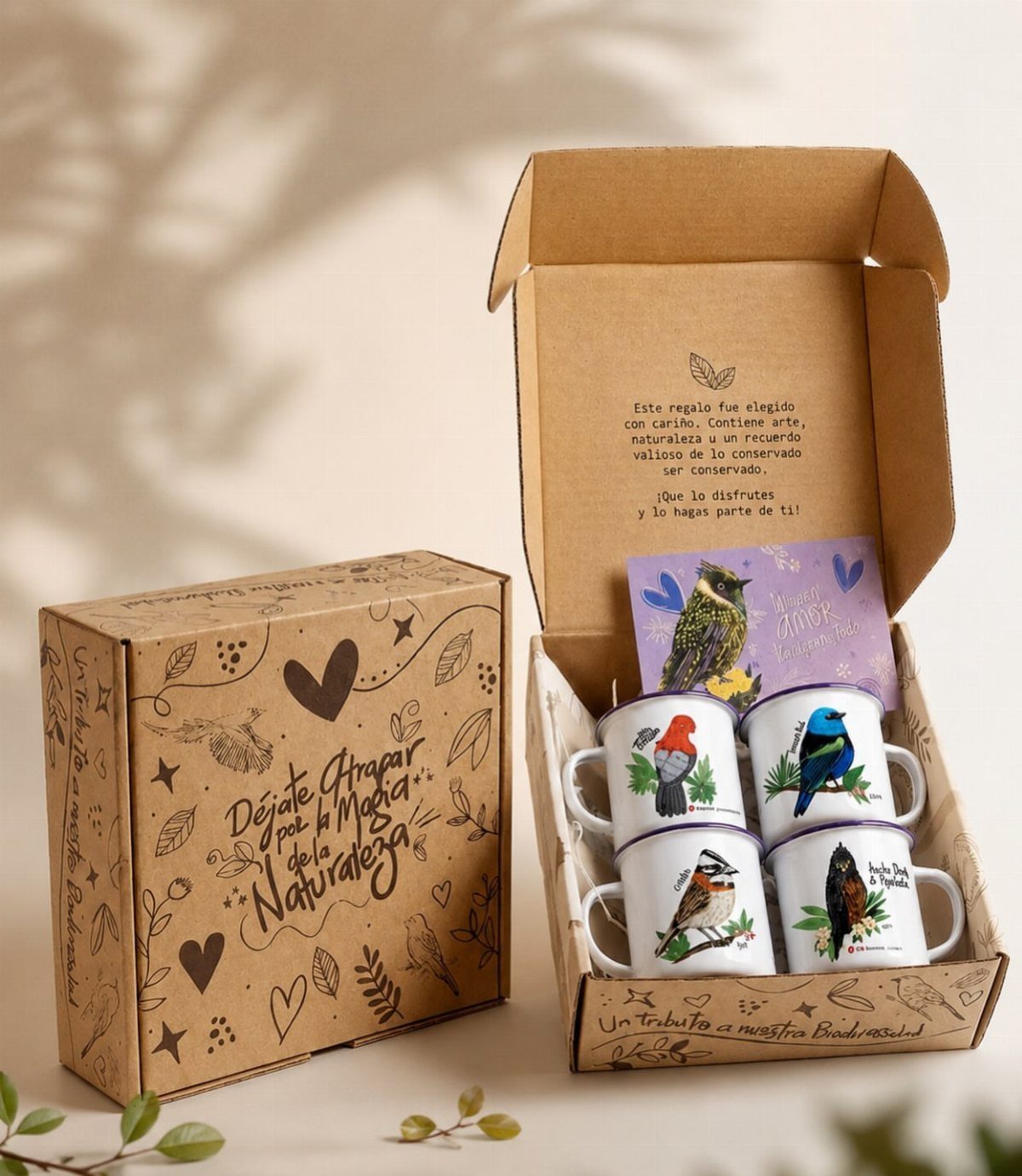 Four bird-themed ceramic mugs arranged inside a brown cardboard gift box.