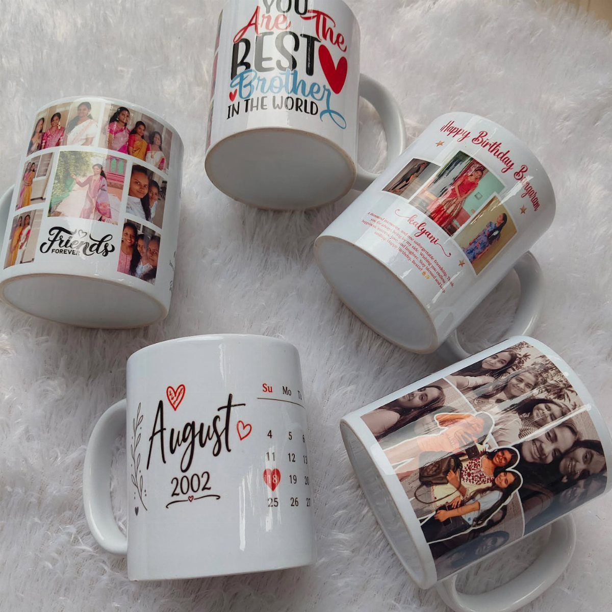 Five custom white mugs with personalized photos and text on a white fluffy rug