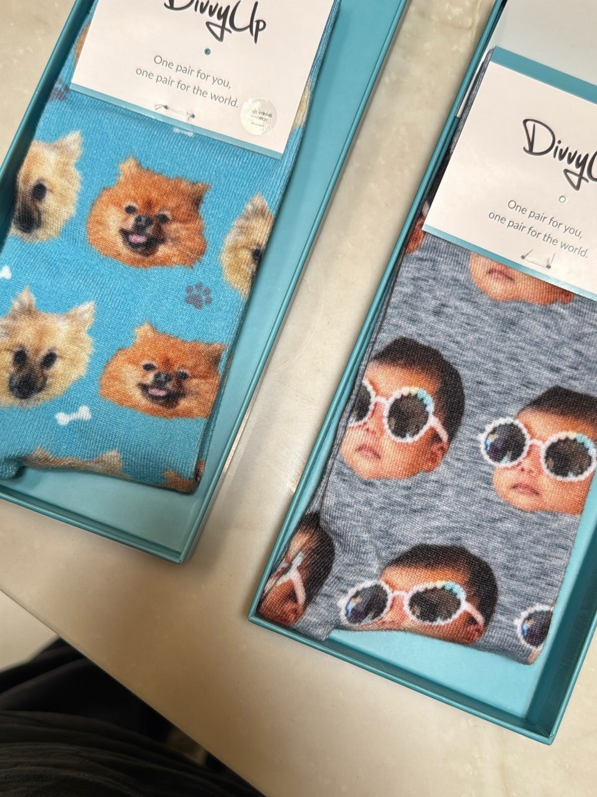 Custom socks featuring repeating patterns of a dog and a baby in boxes.