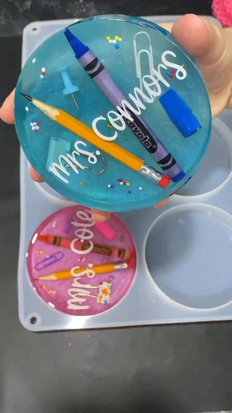 Blue resin paperweight with school supplies and the name Mrs. Connors in cursive