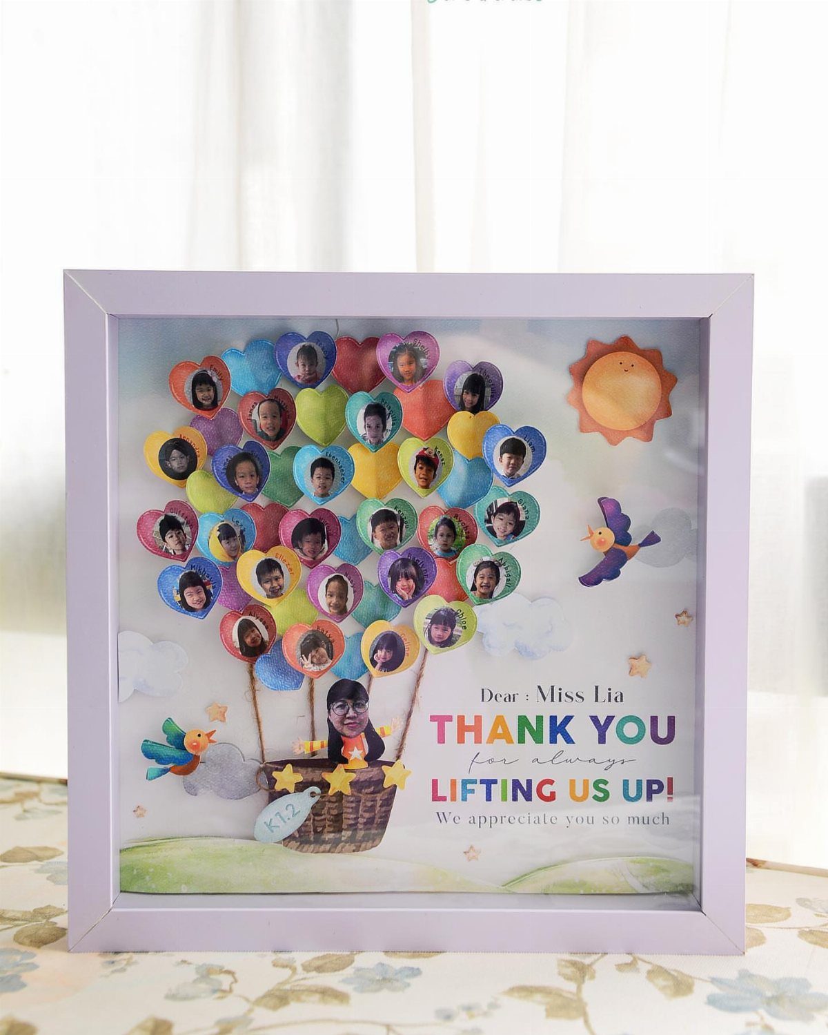 Framed 3D shadow box with heart-shaped student photos forming a hot air balloon.