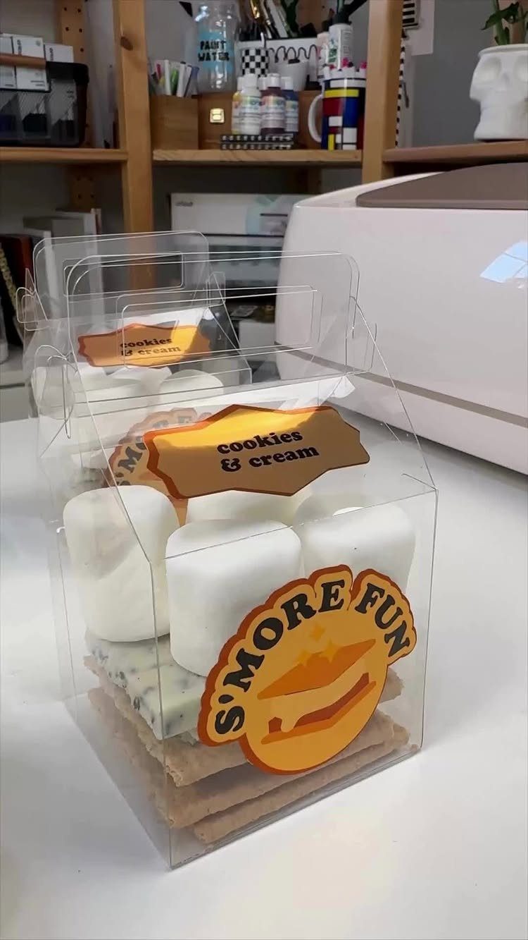 S'mores kits in clear plastic boxes with graham crackers, marshmallows, and chocolate.