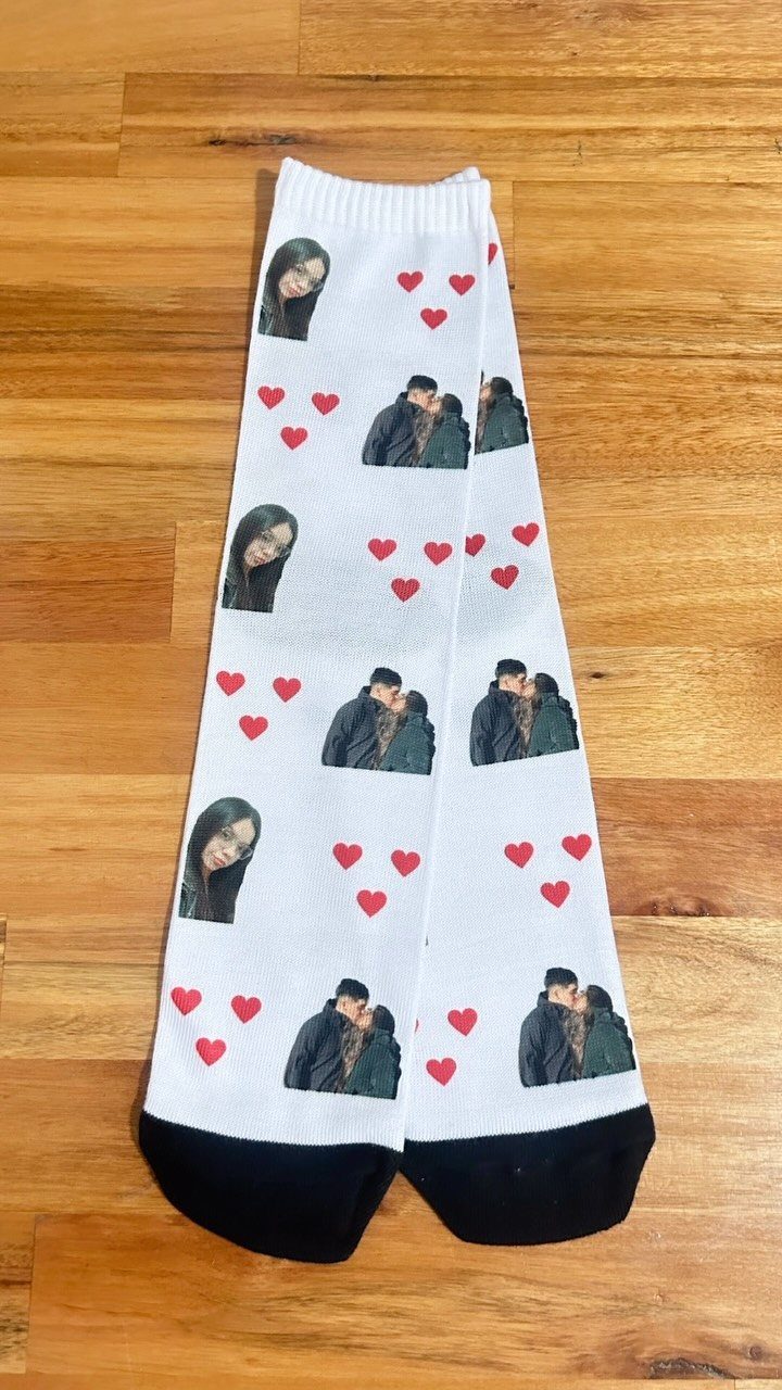 White crew socks with custom photos of a couple and red hearts.