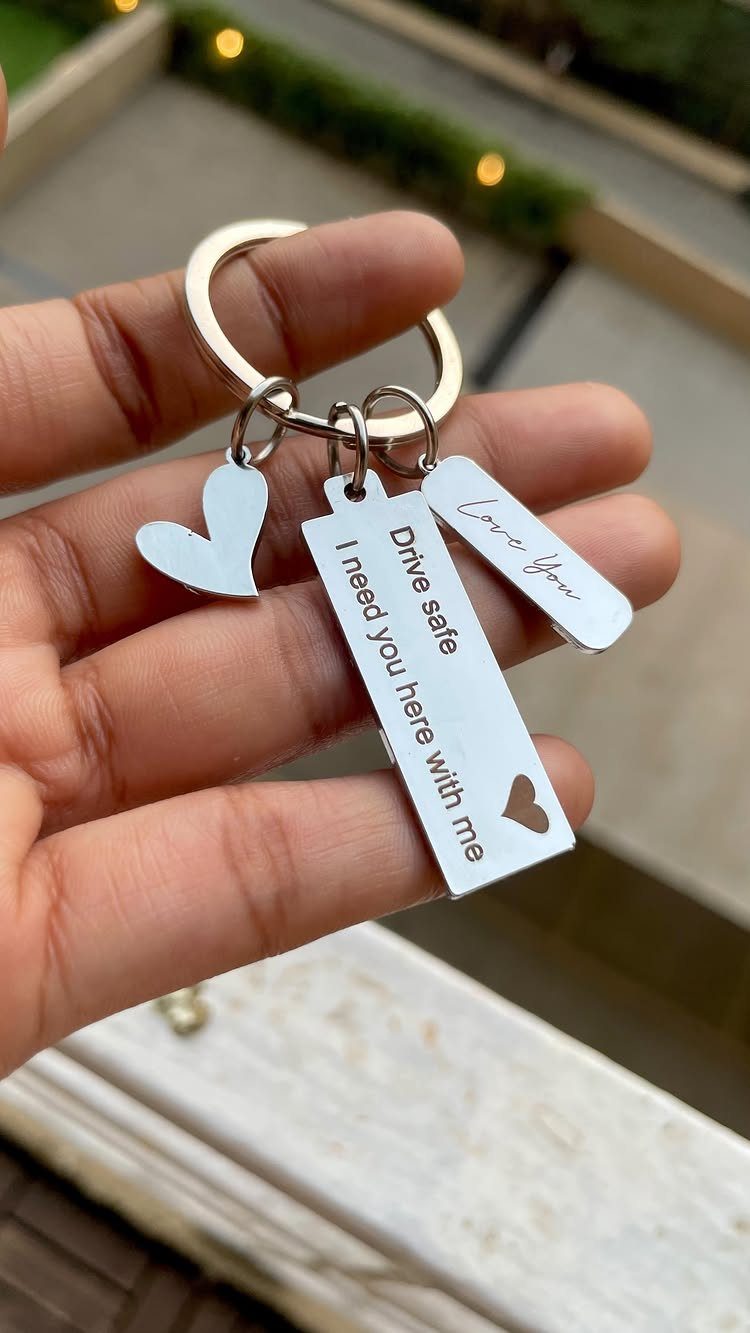 Silver metal keychain with heart and engraved bars saying Drive safe and Love You