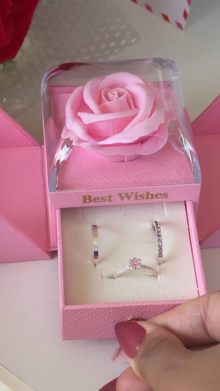 Silver ring and earrings in a pink jewelry box with a pink rose.