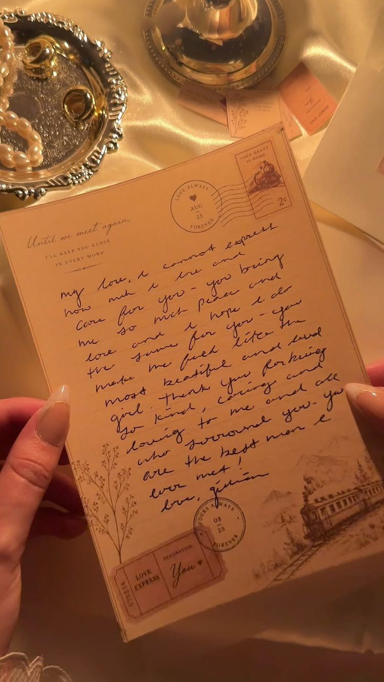Handwritten love letter on vintage paper held by hands over jewelry and satin.