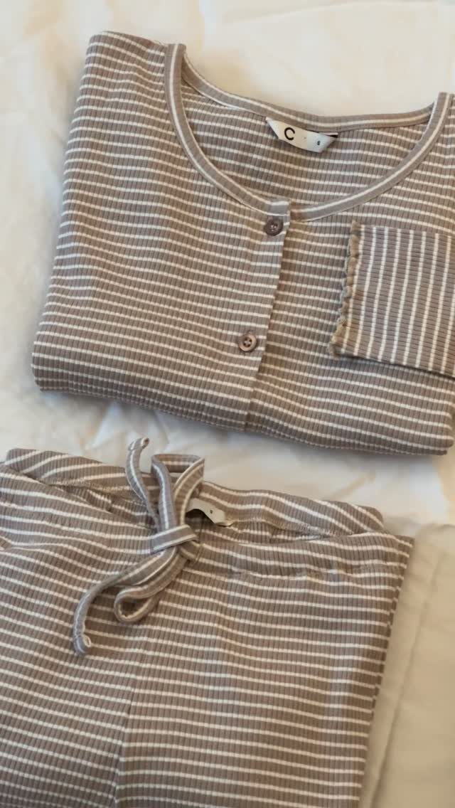 Beige and white striped loungewear set with button top and drawstring pants.