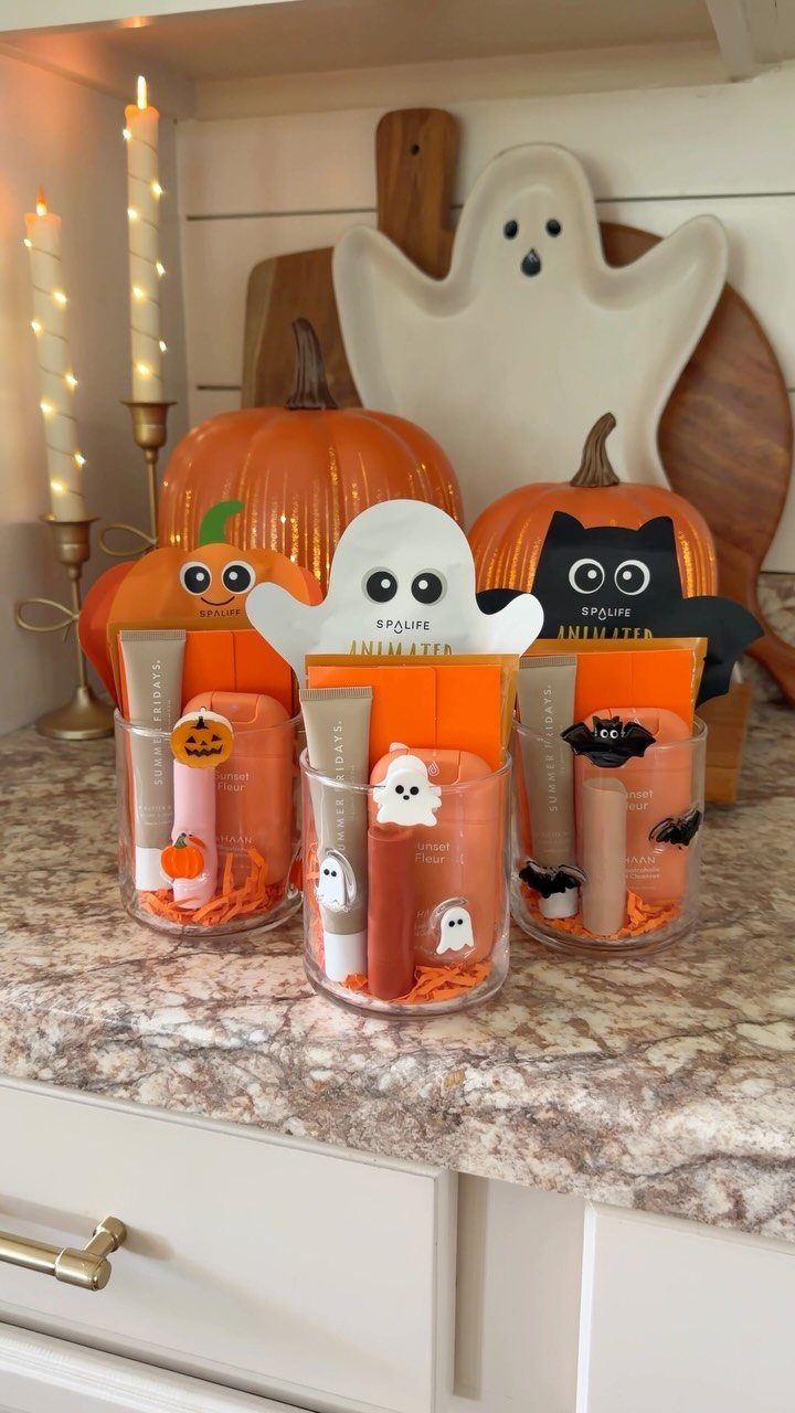 Halloween themed self care gift cups with beauty products and festive decorations