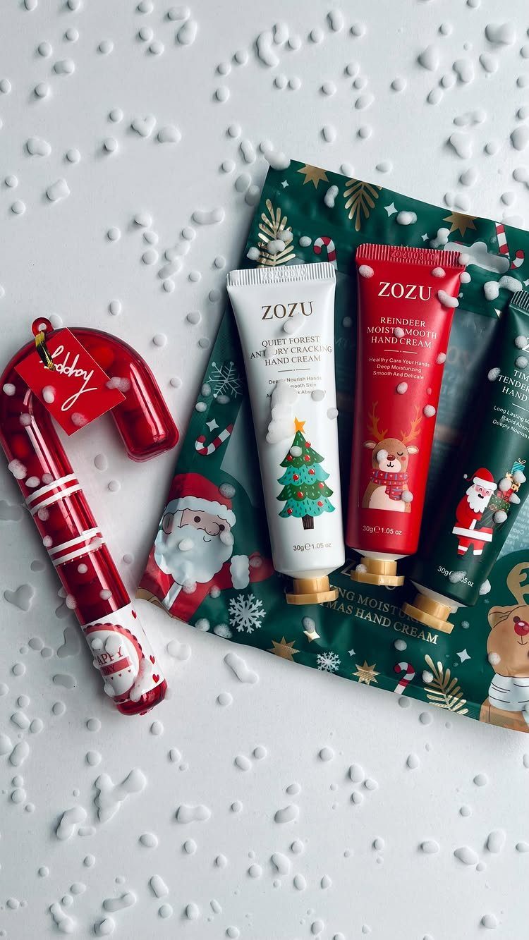 Zozu hand cream tubes and a candy cane on a snowy Christmas background
