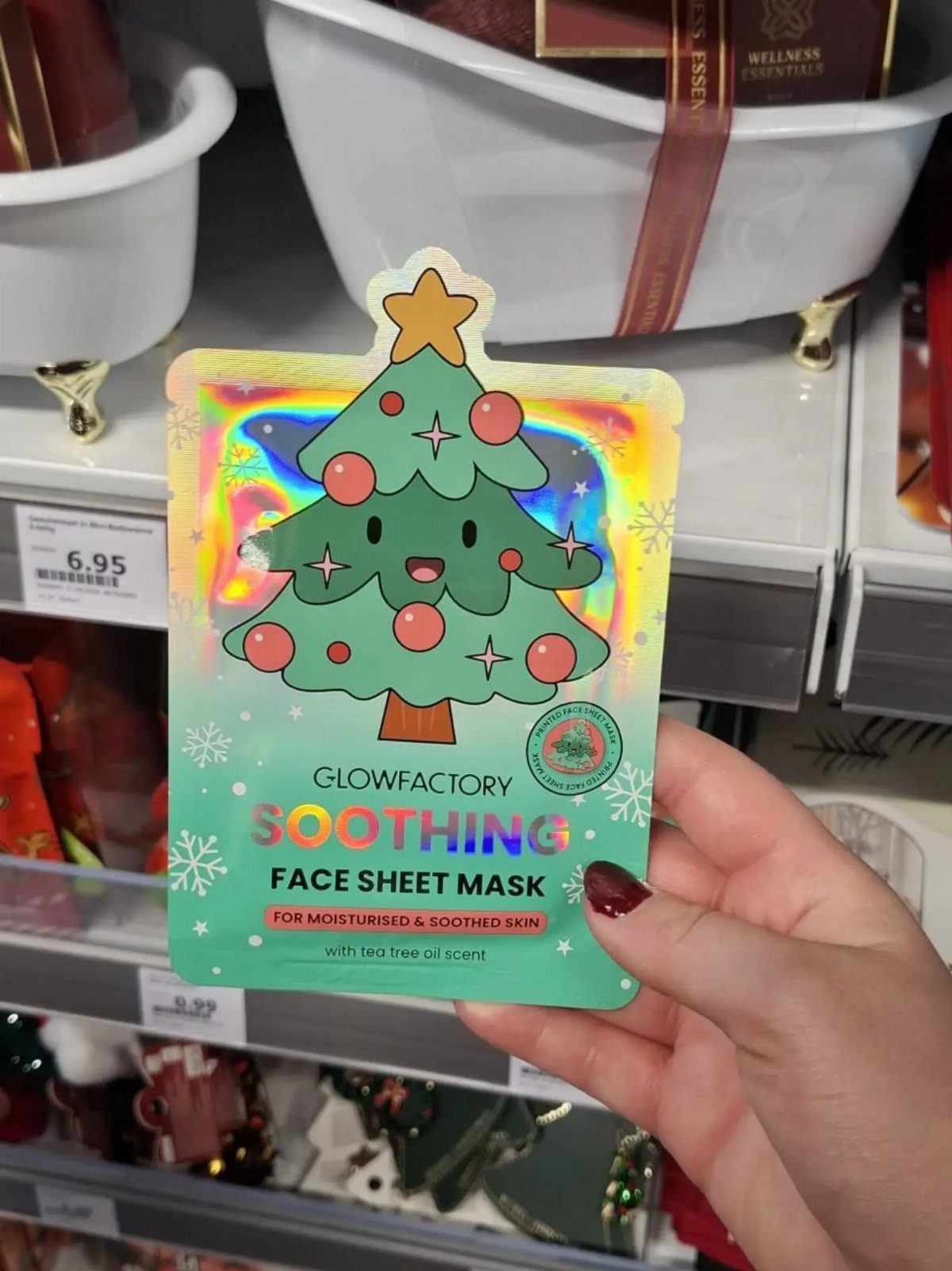 Glowfactory Soothing Face Sheet Mask package with a cartoon Christmas tree held by hand.