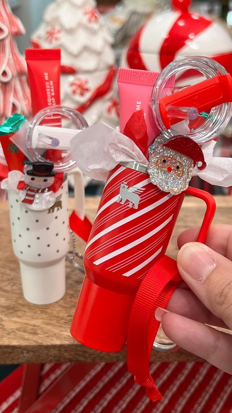 Red striped stocking container filled with small gifts and a Santa charm.