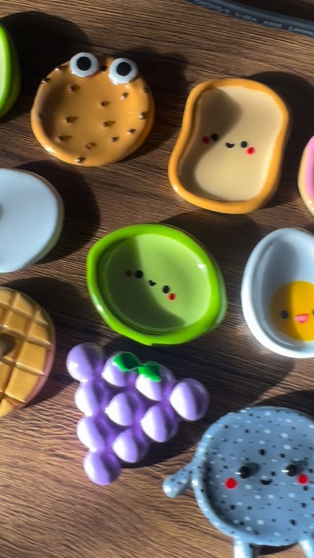 Small colorful ceramic trinket dishes shaped like food with cute smiley faces.