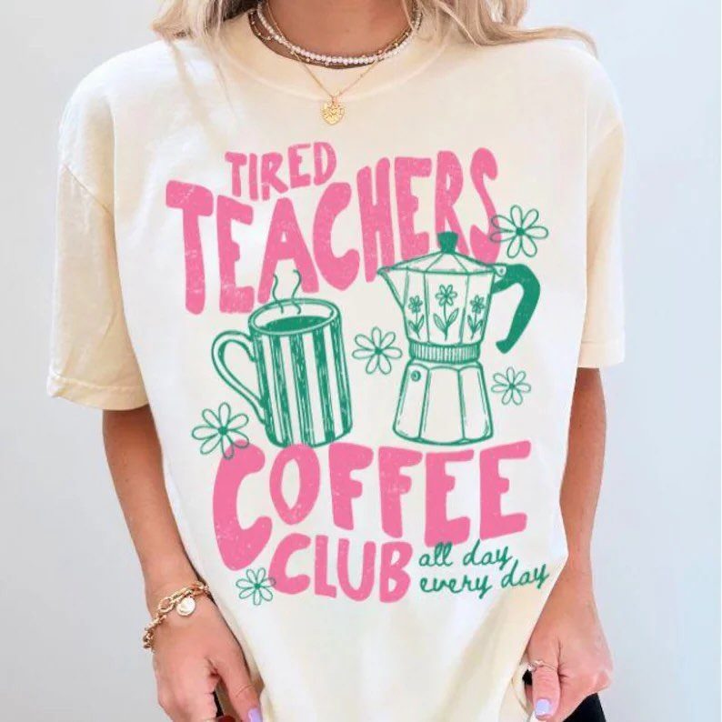 Cream t-shirt with pink and green Tired Teachers Coffee Club graphic design.