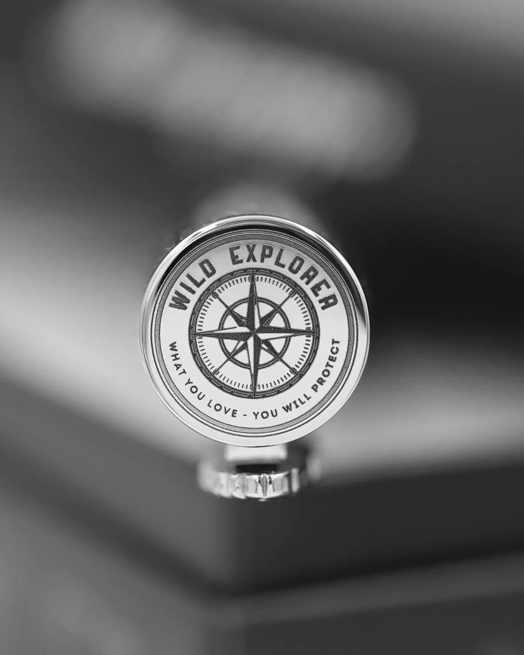 Engraved metal compass with a compass rose and sentimental text on the face.