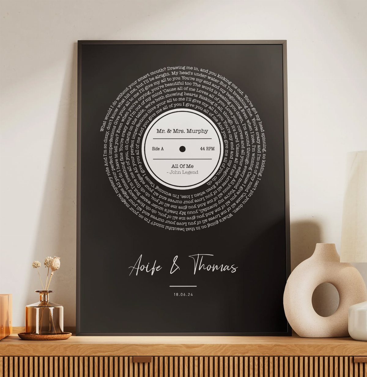 Framed black poster with a vinyl record graphic made of handwritten text.