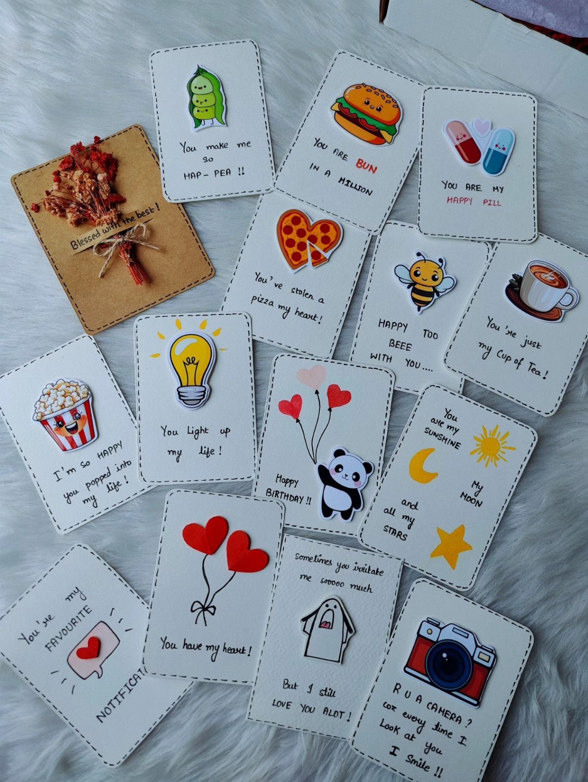 Handmade romantic cards with cute illustrations and puns on a white furry background