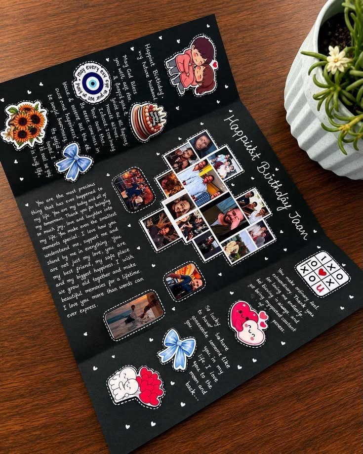Handmade black folding card with photos, handwritten messages, and colorful stickers on wood.