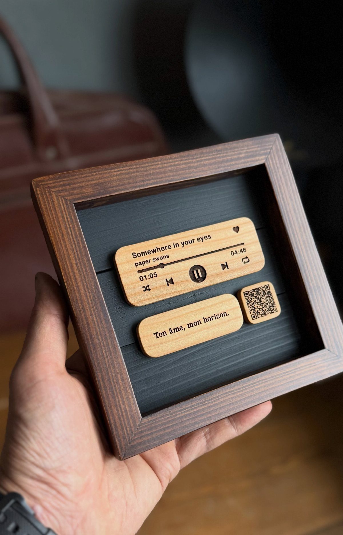 Wooden framed art with music player interface and QR code on wooden plaques
