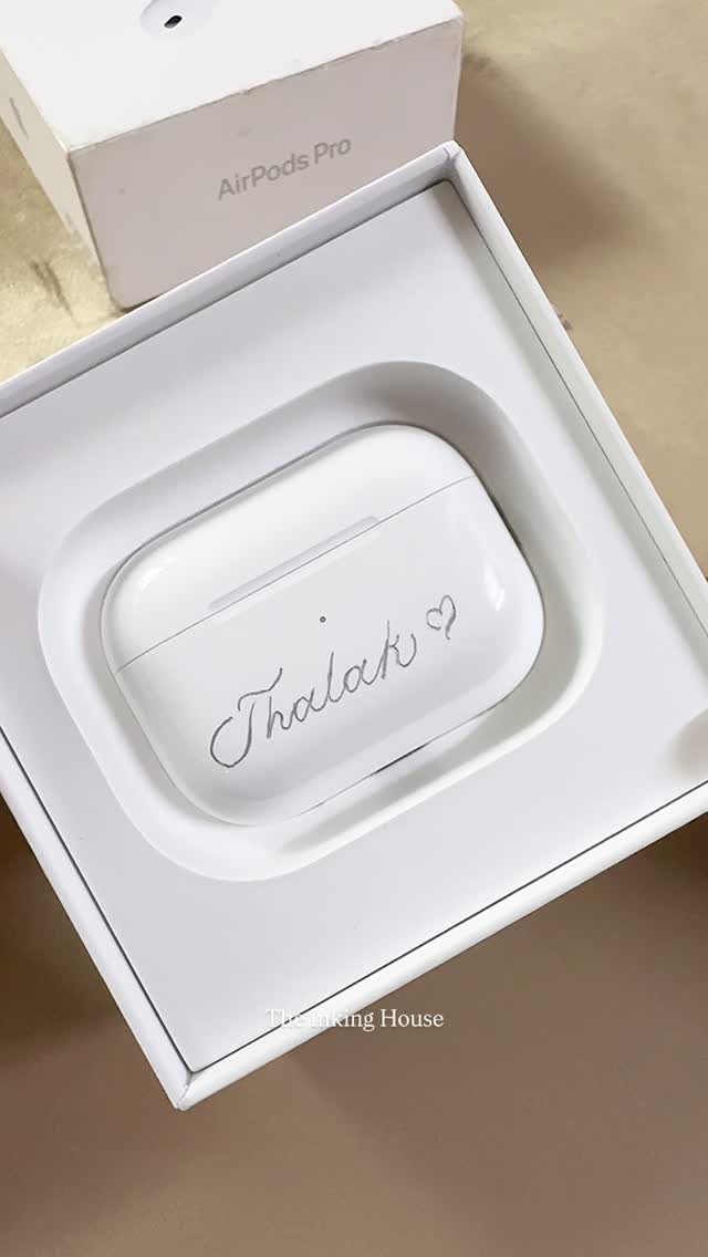 Engraved white AirPods Pro case with a name and heart in a box