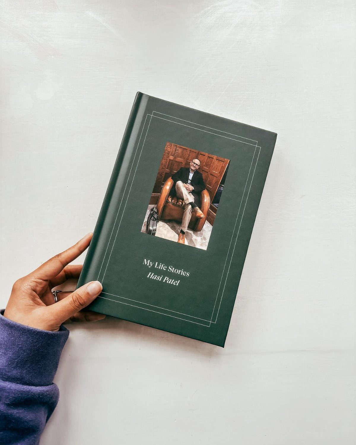 Dark green hardcover book titled My Life Stories featuring a portrait of a man.