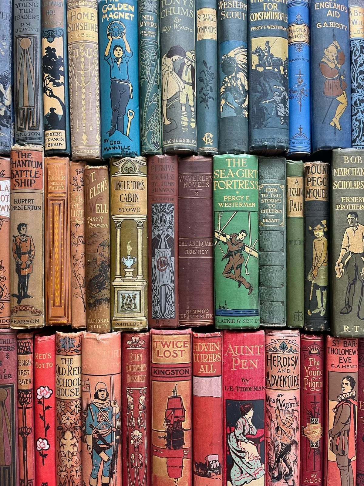 Vintage hardcover books with illustrated spines arranged in colorful horizontal rows.