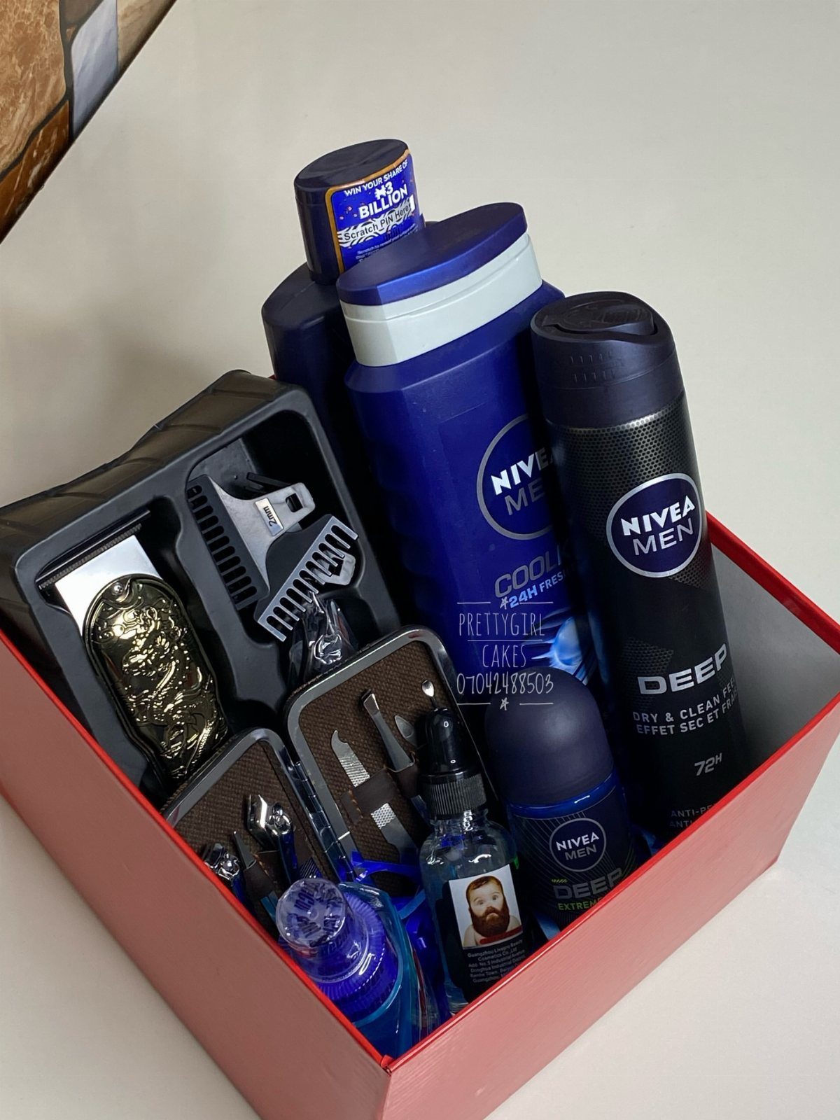 Men's grooming gift set in a red box with razors and Nivea products.